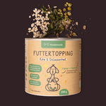 A canister labeled Futtertopping Ruhe & Gelassenheit features a dog illustration, with herbs and flowers scattered above it.